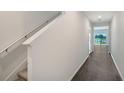 Bright hallway with hardwood floors leading to a living space with large windows at 13116 Bayberry Way, Parrish, FL 34219