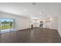 Spacious open-concept living room and kitchen with stainless steel appliances at 13116 Bayberry Way, Parrish, FL 34219