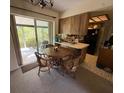 Dining area near kitchen features sliding door to the screened patio at 13406 Leatherbury Ave, Port Charlotte, FL 33953