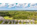 An aerial view shows the house surrounded by lush greenery and ponds, providing a sense of privacy at 14921 Barrows Bluff Ter, Bradenton, FL 34212