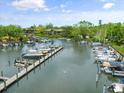 Scenic aerial view of the community marina with multiple boats docked on a sunny day at 1703 Pelican Cove Rd # 356, Sarasota, FL 34231
