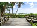 Picturesque boardwalk with lush greenery and glimpses of the waterfront at 1703 Pelican Cove Rd # 356, Sarasota, FL 34231