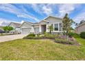 Well-maintained one-story home with three-car garage and beautifully landscaped front yard at 17032 Harvest Moon Way, Bradenton, FL 34211