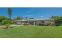 Attractive single-story home with well-manicured lawn and colorful landscaping enhancing curb appeal at 1857 Jasmine Dr, Sarasota, FL 34239