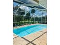 Inviting screened-in pool area with clear blue water and ample space for relaxation and outdoor enjoyment at 2136 Bendway Dr, Port Charlotte, FL 33948