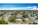 Expansive aerial view of a quiet neighborhood filled with lush trees and well-kept homes at 21966 Belinda Ave, Port Charlotte, FL 33952