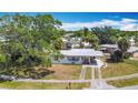 Inviting single story home with a covered carport nestled amidst lush greenery at 21966 Belinda Ave, Port Charlotte, FL 33952
