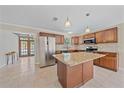 Bright kitchen featuring an island with granite countertops, stainless steel appliances and tile flooring at 2226 Fairfield Ave, Sarasota, FL 34232