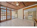 Bright sunroom with tile floor, multiple windows and a ceiling fan at 2226 Fairfield Ave, Sarasota, FL 34232