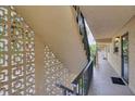 Hallway with textured walls and staircase overlooking building landscape, exterior features light and airy design at 2280 Stickney Point Rd # 420, Sarasota, FL 34231