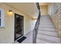 Common area stairwell access with open-air design and textured walls; modern fixtures and clean lines create an inviting space at 2280 Stickney Point Rd # 420, Sarasota, FL 34231