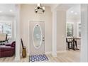 Welcoming foyer with wood floors, decorative door, and natural light at 2306 64Th W St # 17, Bradenton, FL 34209