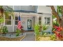Inviting front entrance with an American flag, lush landscaping, and decorative trim at 2306 64Th W St # 17, Bradenton, FL 34209