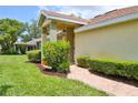 Charming single-story home with brick walkway, manicured greenery, and a well-kept lawn at 2407 New Haven Cir, Sun City Center, FL 33573