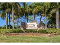 Elegant brick entrance sign for Chestnut Creek, a deed-restricted community, surrounded by lush greenery at 245 Woodingham Trl, Venice, FL 34292