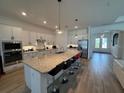 Bright and airy kitchen featuring a large island, stainless steel appliances, and ample counter space at 25240 Keygrass Ct, Punta Gorda, FL 33955