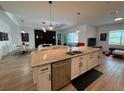 Modern kitchen with a granite island, stainless steel appliances, and stylish cabinetry at 25240 Keygrass Ct, Punta Gorda, FL 33955