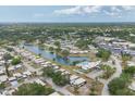 Panoramic aerial view of a tranquil community with a scenic lake, surrounded by lush greenery and well-maintained homes at 3941 Glen Oaks E Dr # 32, Sarasota, FL 34232