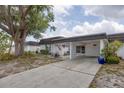 Charming home with a covered carport, mature tree, and a cozy front patio at 3941 Glen Oaks E Dr # 32, Sarasota, FL 34232