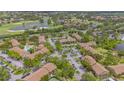 Expansive aerial view of the complex, including the pool, nearby golf course and lakes at 4009 Crockers Lake Blvd # 22, Sarasota, FL 34238