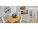 Dining area with a round table, four chairs, and pass through view into the kitchen at 4009 Crockers Lake Blvd # 22, Sarasota, FL 34238