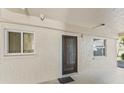 Ground floor entrance featuring storm door, windows and security camera at 4015 Lake Bayshore Dr # 108, Bradenton, FL 34205