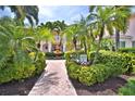 Beautifully landscaped entrance to building featuring lush greenery and a charming fountain at 4264 Central Sarasota Pkwy # 116, Sarasota, FL 34238