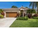 Inviting home with a well-maintained lawn and a modern wood garage door at 4435 Beauchamp Ct, Sarasota, FL 34243