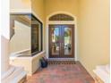 Charming entryway featuring double doors with glass panels and brick-laid porch at 4579 Tuscana Dr, Sarasota, FL 34241