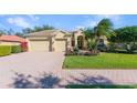 Beautiful single-story home with a well-manicured lawn, brick driveway, and a two-car garage at 4579 Tuscana Dr, Sarasota, FL 34241