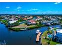 Beautiful aerial view of canal-front homes with boat docks in a waterfront community on a sunny day at 4700 Mainsail Dr, Bradenton, FL 34208