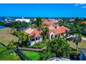Beautiful Florida home with a red tile roof, mature palm trees, and lush green grass at 4700 Mainsail Dr, Bradenton, FL 34208