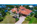 A stylish home with a carport, tile roof, well-kept lawn, and mature landscaping at 4700 Mainsail Dr, Bradenton, FL 34208