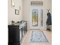 Inviting entryway with decorative glass door, stylish console table, and neutral tile flooring at 4734 Claremont Park Dr, Bradenton, FL 34211