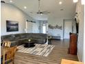 Bright living room with vaulted ceilings, hardwood floors, stylish decor, and a comfortable sectional sofa at 48 Lark Dr, Placida, FL 33946