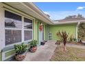 Close up shot of the front of the home with colorful, decorative flower pots and a purple front door at 5353 Starwood Pl, Sarasota, FL 34232
