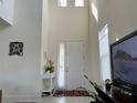 Bright foyer featuring high ceilings, neutral walls, decorative accents, and a front door view at 5521 Summit Gln, Bradenton, FL 34203