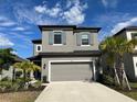 Beautiful two story home with gray tones, well manicured landscaping, and a two car garage at 5521 Summit Gln, Bradenton, FL 34203