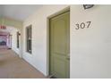 Inviting entrance door marked '307' with a hallway view and 'Exit' sign, set in neutral tones at 555 N Orange Ave # 307, Sarasota, FL 34236