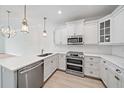 Beautiful kitchen boasts stainless steel appliances, quartz countertops, and sleek white cabinetry at 555 N Orange Ave # 307, Sarasota, FL 34236