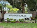 Entrance to Garden Lakes community, featuring landscaped gardens and brick pillars at 5705 Garden Lakes Majestic, Bradenton, FL 34203