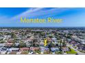 Aerial view of the property with an arrow showing its location on a neighborhood near the Manatee River at 6012 11Th W Ave, Bradenton, FL 34209