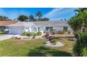 Lovely home with a well-maintained lawn, colorful landscaping, and an attached garage at 6012 11Th W Ave, Bradenton, FL 34209