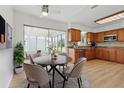 Eat-in kitchen with modern appliances, wood cabinets, and bright dining area at 6116 Rodgers Ave, Sarasota, FL 34231