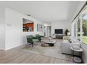 Bright living room with large windows, hardwood floors, and stylish furniture at 6116 Rodgers Ave, Sarasota, FL 34231