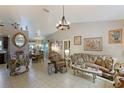 Elegant living room featuring a chandelier, decorative furniture, and neutral wall color at 620 Burke Rd, Venice, FL 34293