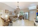 Elegant living room featuring a chandelier, decorative furniture, and neutral wall color at 620 Burke Rd, Venice, FL 34293