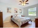 Cozy bedroom with wood floors, coastal-themed decor, and ample natural light at 6240 Falcon Lair Dr, North Port, FL 34287