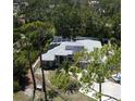 Aerial view of a home featuring a screened-in pool and solar panels at 652 N Elm St, Englewood, FL 34223