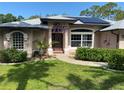 Inviting front door with decorative accents and lush landscaping creates a welcoming entrance at 652 N Elm St, Englewood, FL 34223
